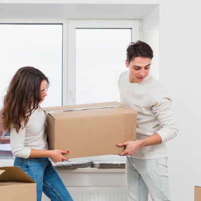 young-couple-carrying-big-cardboard-box-new-home_23-2148060113